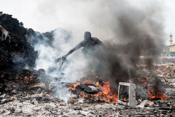Nachhaltig telefonieren - Arbeiter vor brennendem Elektroschrott auf der Müllkippe von Agbogbloshie, Accra, Ghana